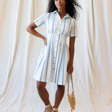 Model wearing Seaside Stripe Dress with a collared neckline and pleated skirt, perfect for nursing and outings.