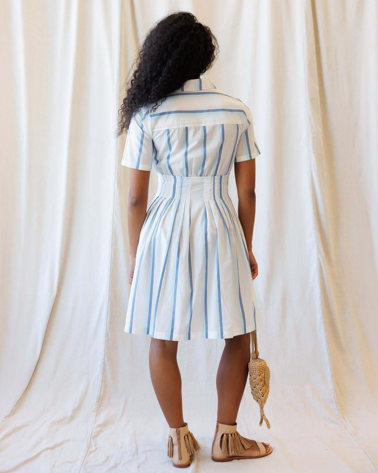 Back view of the Seaside Stripe Dress featuring a collared neckline, A-line pleated skirt, and nursing friendly design.