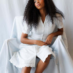Model wearing the Swiss Dot Scallop Dress with puff sleeves, showcasing pintuck details and a relaxed style.