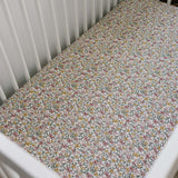 Sunny Petals Muslin Crib Sheet | Transform your baby's crib into a cozy haven with our Sunny Petals Muslin Crib Sheet. Crafted from our exclusive soft and breathable muslin fabric, this sheet showcases a neutral design that adds a touch of warmth and styl