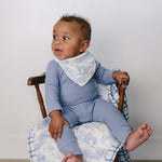 Farm Toile + Blue & Green Plaid Muslin Quilt | Indulge your little one in the cozy comfort of our Muslin Quilt. Crafted from the same fabric as our beloved muslin swaddles, this four-layer quilt offers warmth and softness for a restful sleep. Our neutral