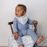 Farm Toile + Blue & Green Plaid Muslin Quilt | Indulge your little one in the cozy comfort of our Muslin Quilt. Crafted from the same fabric as our beloved muslin swaddles, this four-layer quilt offers warmth and softness for a restful sleep. Our neutral