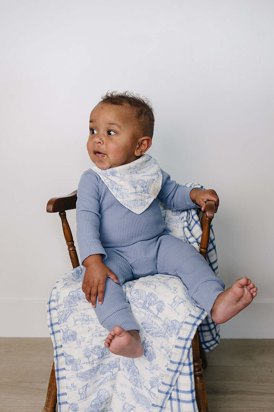 Farm Toile + Blue & Green Plaid Muslin Quilt | Indulge your little one in the cozy comfort of our Muslin Quilt. Crafted from the same fabric as our beloved muslin swaddles, this four-layer quilt offers warmth and softness for a restful sleep. Our neutral