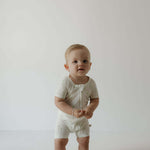 Shortie Bamboo Zip | Palm | Milk & Baby | Made of the softest premium bamboo. Durable and well designed your little ones can sleep and play in these cozy pajamas. These shortie rompers are ideal for warmer months featuring short sleeves and short bottoms.