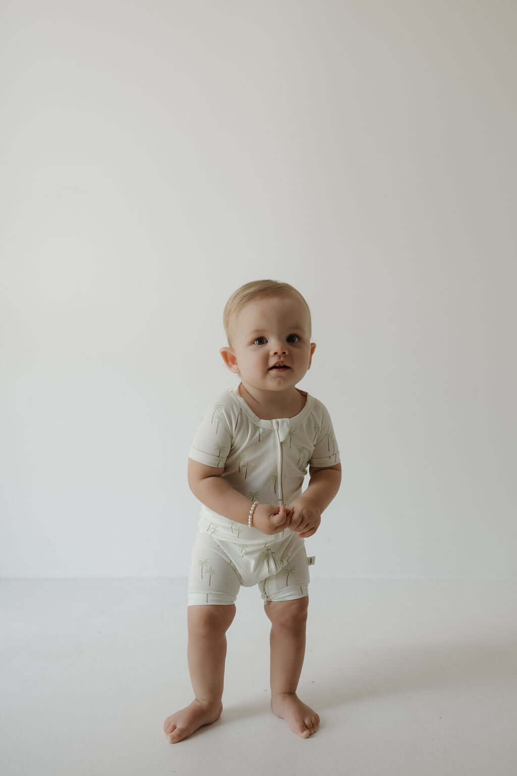 Shortie Bamboo Zip | Palm | Milk & Baby | Made of the softest premium bamboo. Durable and well designed your little ones can sleep and play in these cozy pajamas. These shortie rompers are ideal for warmer months featuring short sleeves and short bottoms.