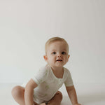 Shortie Bamboo Zip | Palm | Milk & Baby | Made of the softest premium bamboo. Durable and well designed your little ones can sleep and play in these cozy pajamas. These shortie rompers are ideal for warmer months featuring short sleeves and short bottoms.