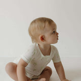 Shortie Bamboo Zip | Palm | Milk & Baby | Made of the softest premium bamboo. Durable and well designed your little ones can sleep and play in these cozy pajamas. These shortie rompers are ideal for warmer months featuring short sleeves and short bottoms.