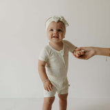 Palm | Bamboo Head Wrap | Milk & Baby | Made from silky-soft bamboo material, this adjustable head wrap features a sweet bow for added style. Perfect for babies and toddlers!One size fits most Print: Palm (a palm tree print on cream background) Material: