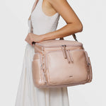 Caraa Baby Bag Medium in Blush Nylon carried by a model, showcasing its stylish design and practicality for parents.