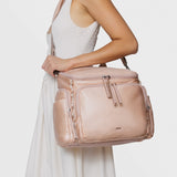 Caraa Baby Bag Medium in Blush Nylon carried by a model, showcasing its stylish design and practicality for parents.