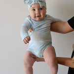 Blue Bows | Long Sleeve Bamboo Snapsuit | Made from the softest premium bamboo in our classic solid black, this snapsuit is cozy, durable, and easy to wear all day long. Designed for sleeping, playing, and everything in between, it features snap closures