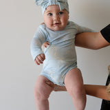 Blue Bows | Long Sleeve Bamboo Snapsuit | Made from the softest premium bamboo in our classic solid black, this snapsuit is cozy, durable, and easy to wear all day long. Designed for sleeping, playing, and everything in between, it features snap closures