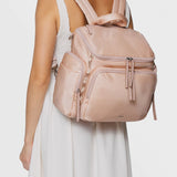 Caraa Baby Bag Medium in Blush Nylon worn as a backpack from the back view, showcasing its stylish design and functionality.