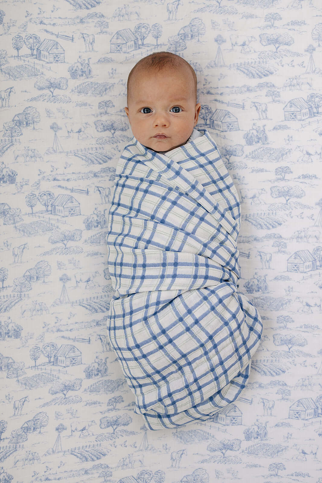 Farm Toile Muslin Crib Sheet | Transform your baby's crib into a cozy haven with our Farm Toile Muslin Crib Sheet. Crafted from our exclusive soft and breathable muslin fabric, this sheet showcases a neutral design that adds a touch of warmth and style to