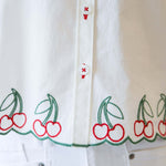 Cherry Cute Button Down showcasing embroidered cherry details and button placket for a charming design.