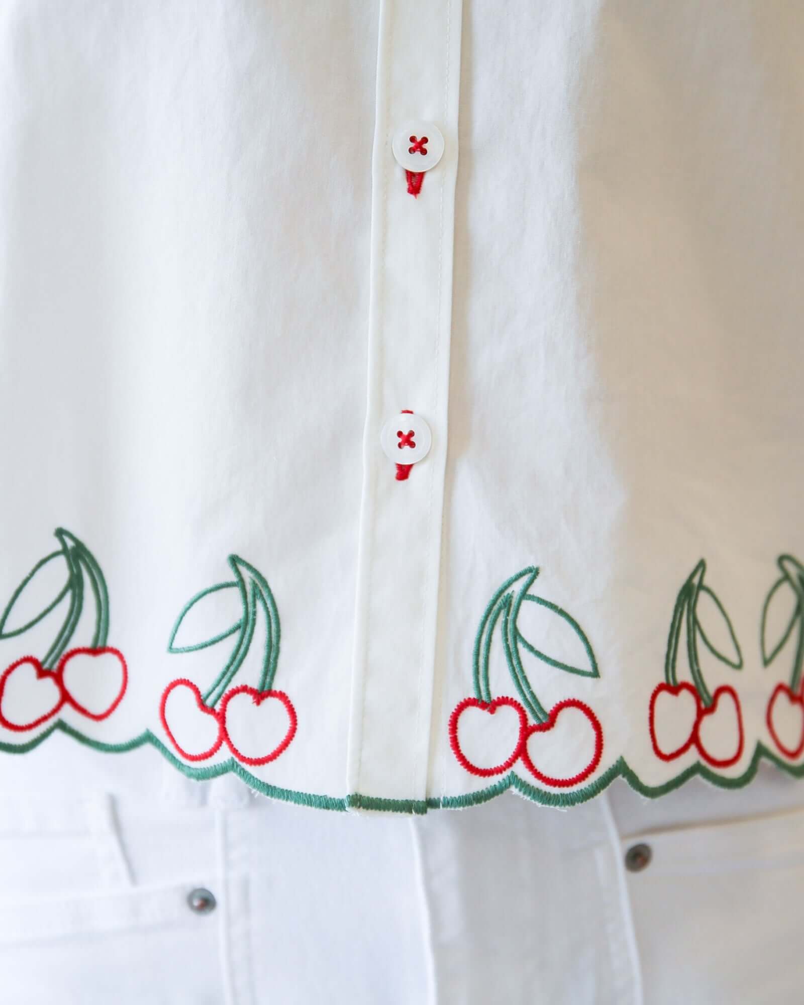 Cherry Cute Button Down showcasing embroidered cherry details and button placket for a charming design.