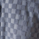 Close-up of a textured gray fabric with a checkered pattern