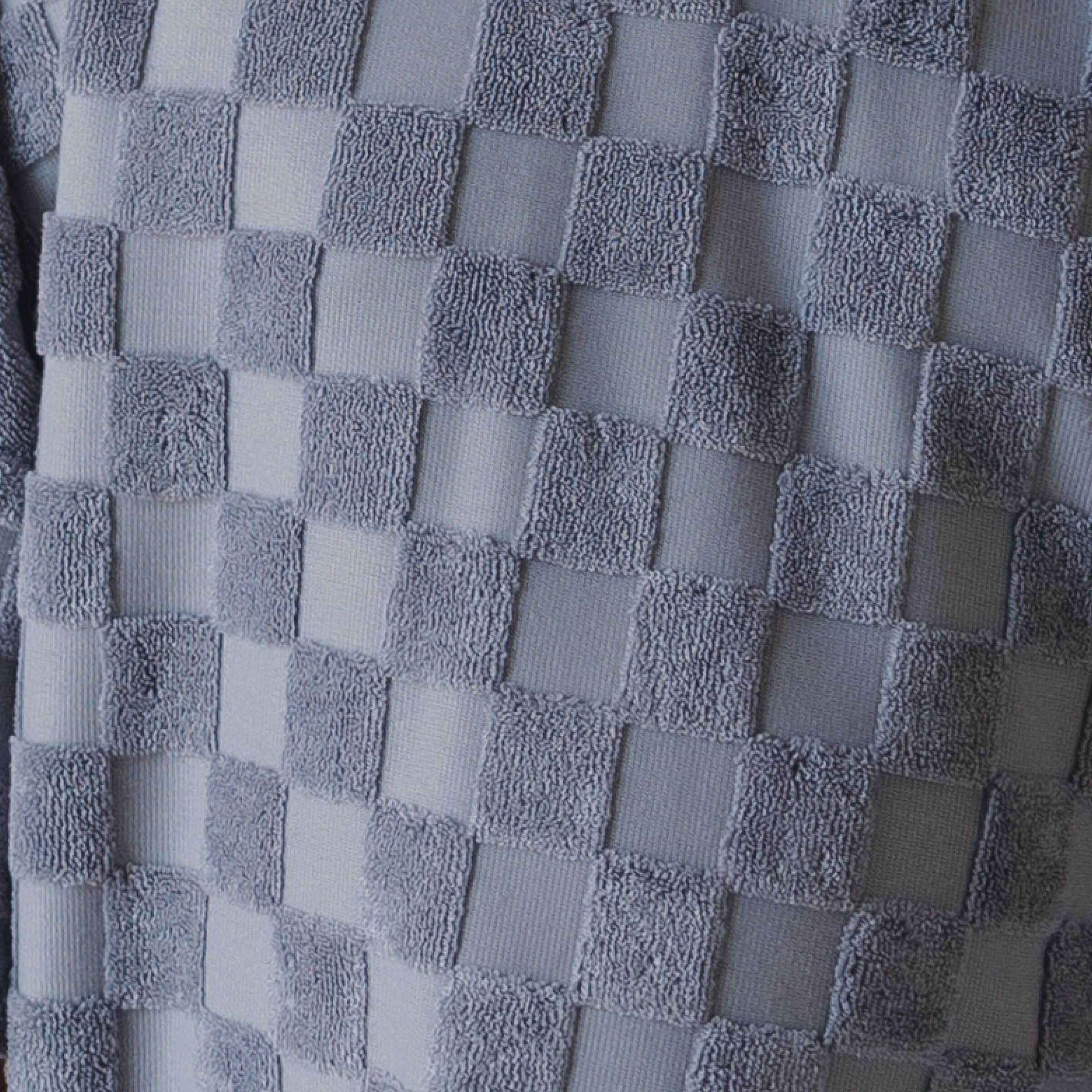Close-up of a textured gray fabric with a checkered pattern