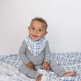 Farm Toile + Blue & Green Plaid Muslin Quilt | Indulge your little one in the cozy comfort of our Muslin Quilt. Crafted from the same fabric as our beloved muslin swaddles, this four-layer quilt offers warmth and softness for a restful sleep. Our neutral