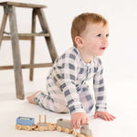 Toddler playing with wooden train while wearing Slate Gingham | Zip Romper, showcasing comfort and style.