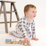 Toddler playing with wooden train while wearing Slate Gingham | Zip Romper, showcasing comfort and style.