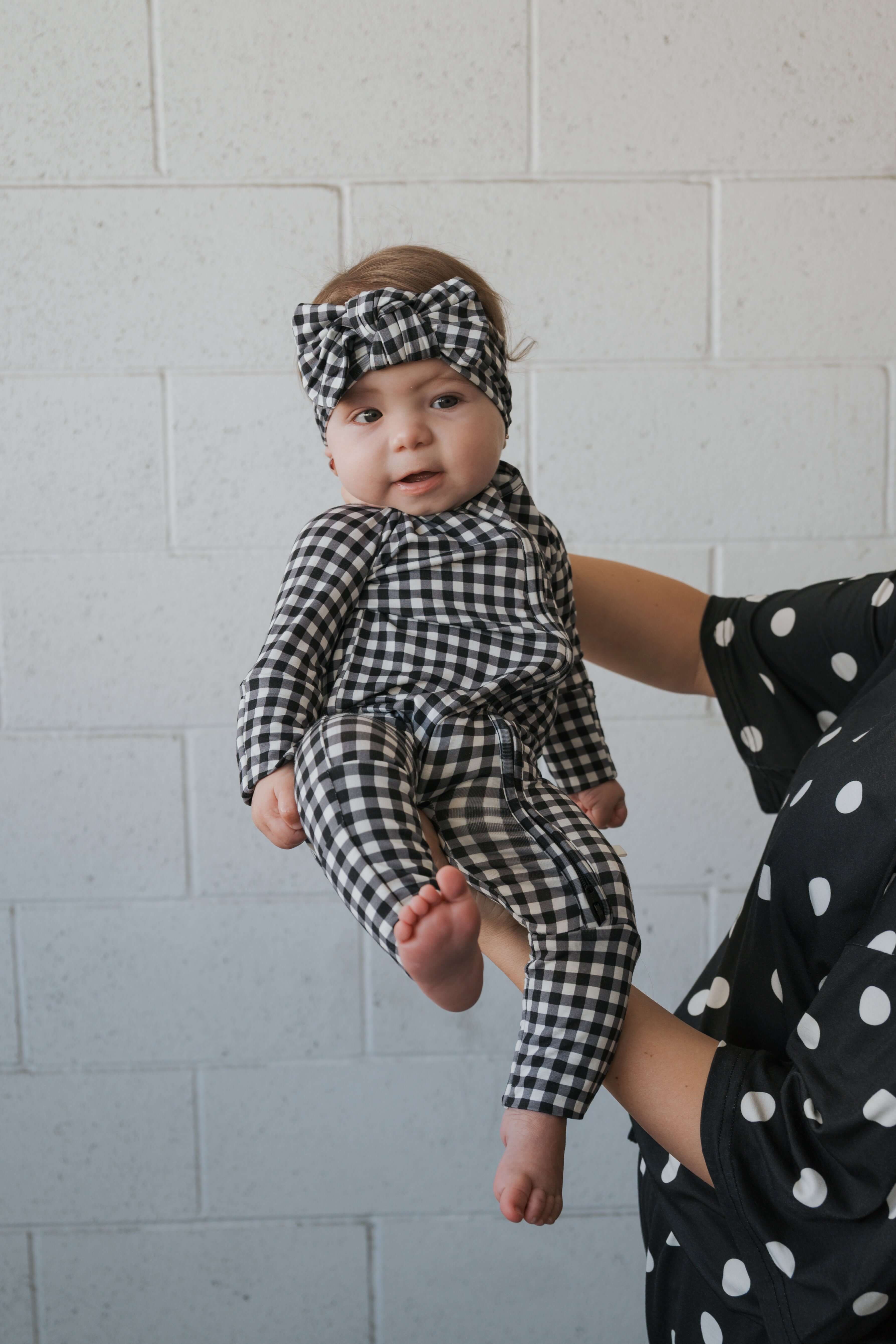 Black Gingham | Bamboo Head Wrap | Made from silky-soft bamboo material, this adjustable head wrap features a sweet bow for added style. Perfect for babies and toddlers!One size fits most Print: Black Gingham Material: 95% bamboo viscose / 5% spandex Care