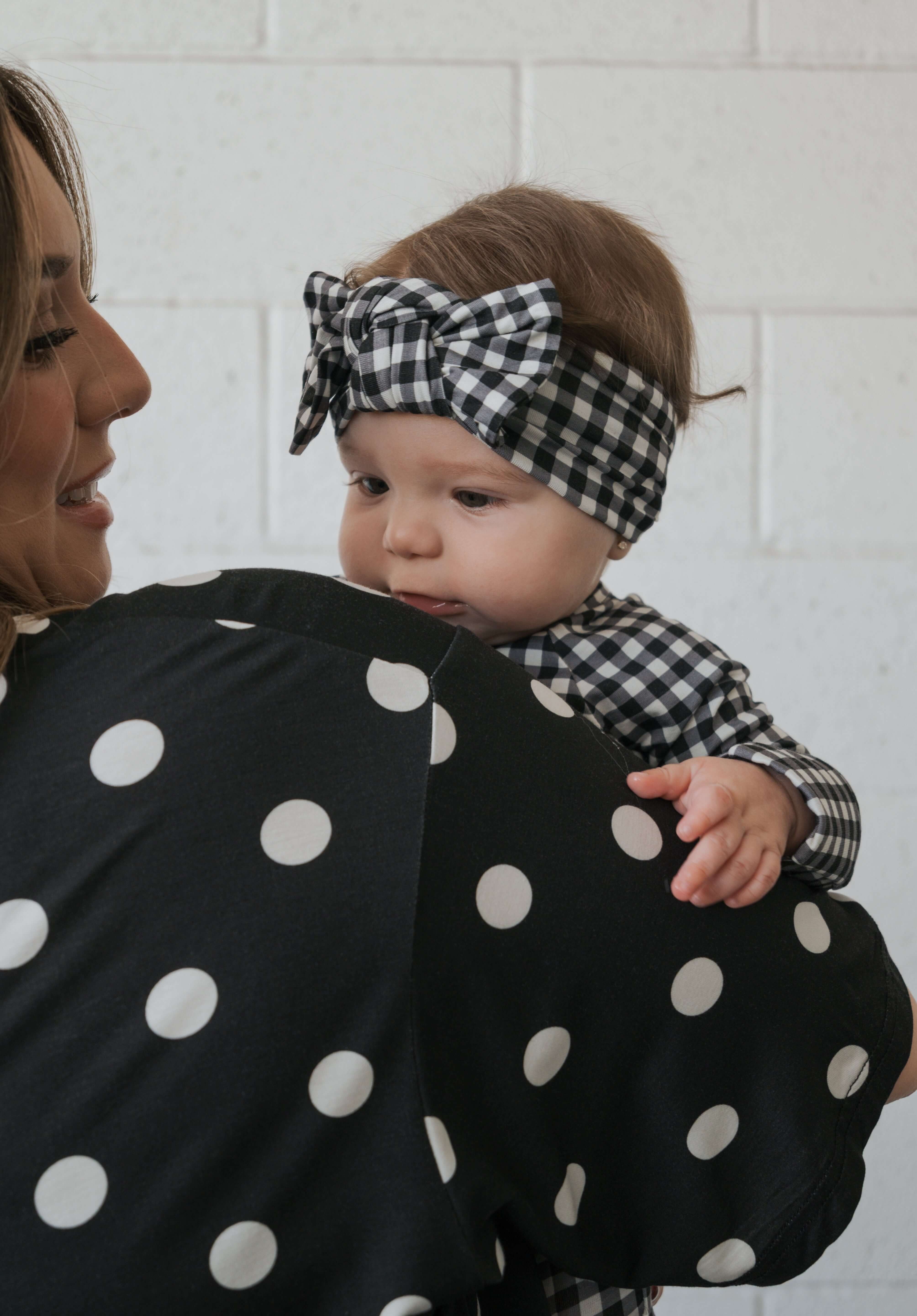 Black Gingham | Bamboo Head Wrap | Made from silky-soft bamboo material, this adjustable head wrap features a sweet bow for added style. Perfect for babies and toddlers!One size fits most Print: Black Gingham Material: 95% bamboo viscose / 5% spandex Care