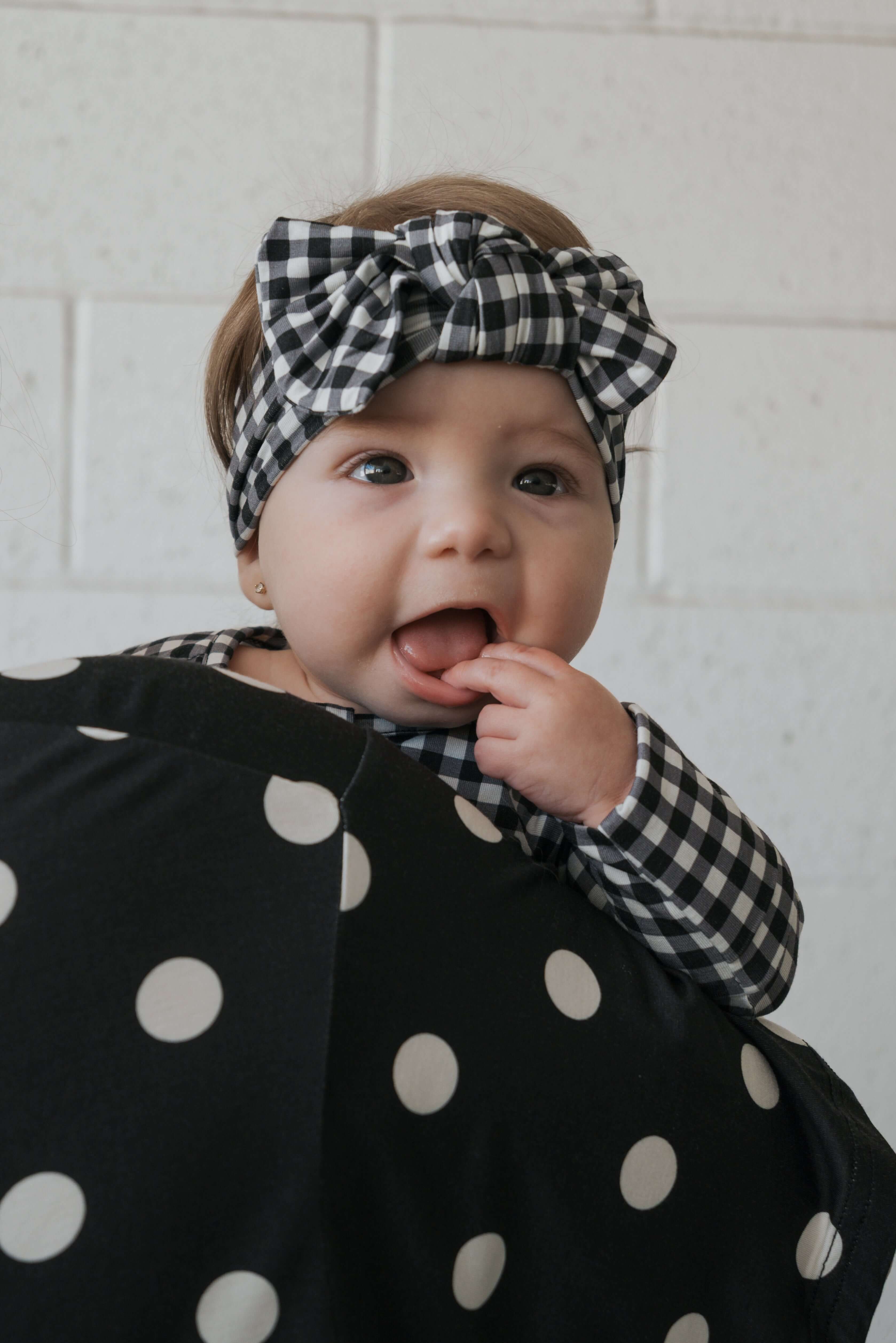Black Gingham | Bamboo Head Wrap | Made from silky-soft bamboo material, this adjustable head wrap features a sweet bow for added style. Perfect for babies and toddlers!One size fits most Print: Black Gingham Material: 95% bamboo viscose / 5% spandex Care