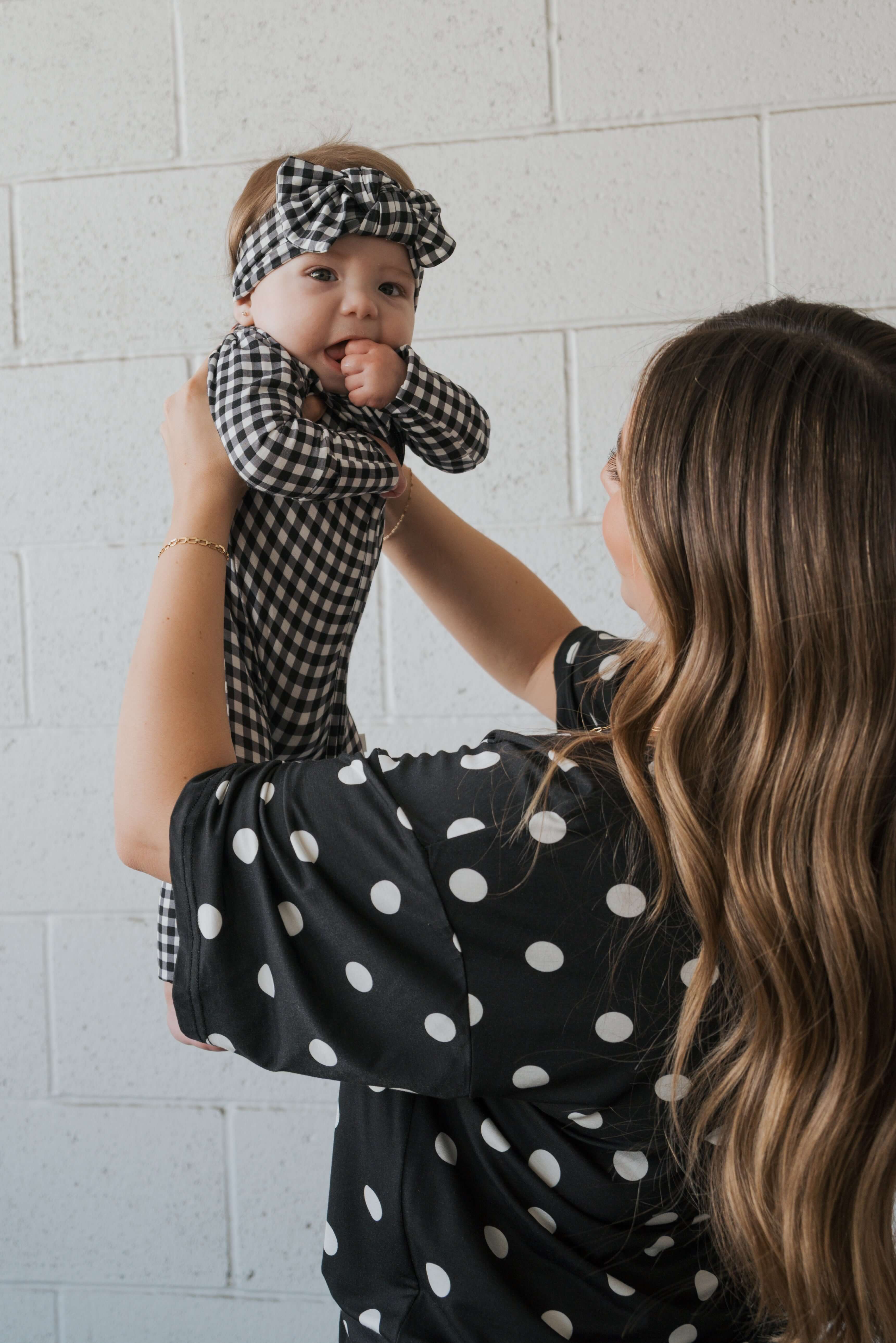 Black Gingham | Bamboo Head Wrap | Made from silky-soft bamboo material, this adjustable head wrap features a sweet bow for added style. Perfect for babies and toddlers!One size fits most Print: Black Gingham Material: 95% bamboo viscose / 5% spandex Care