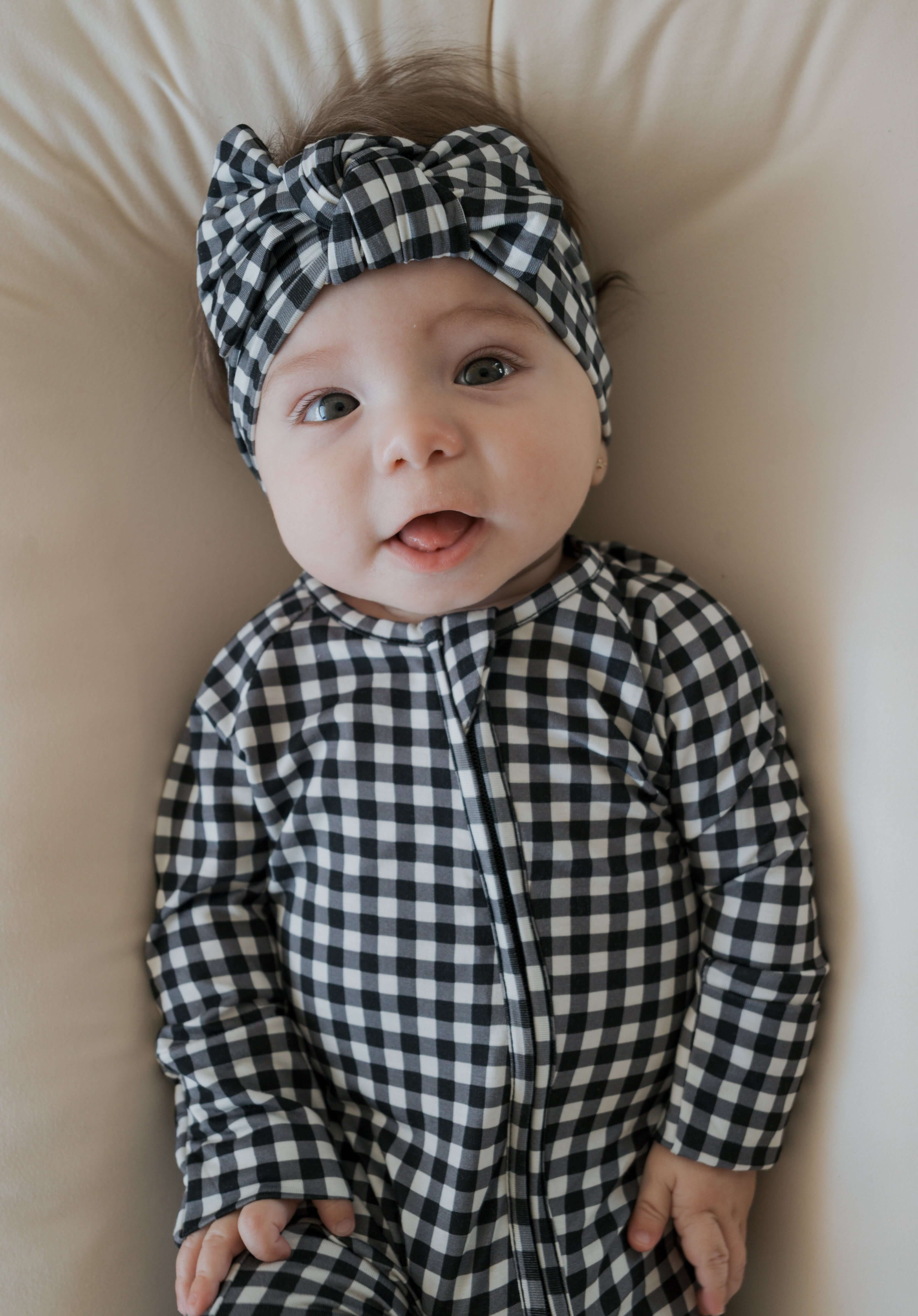 Black Gingham | Bamboo Head Wrap | Made from silky-soft bamboo material, this adjustable head wrap features a sweet bow for added style. Perfect for babies and toddlers!One size fits most Print: Black Gingham Material: 95% bamboo viscose / 5% spandex Care