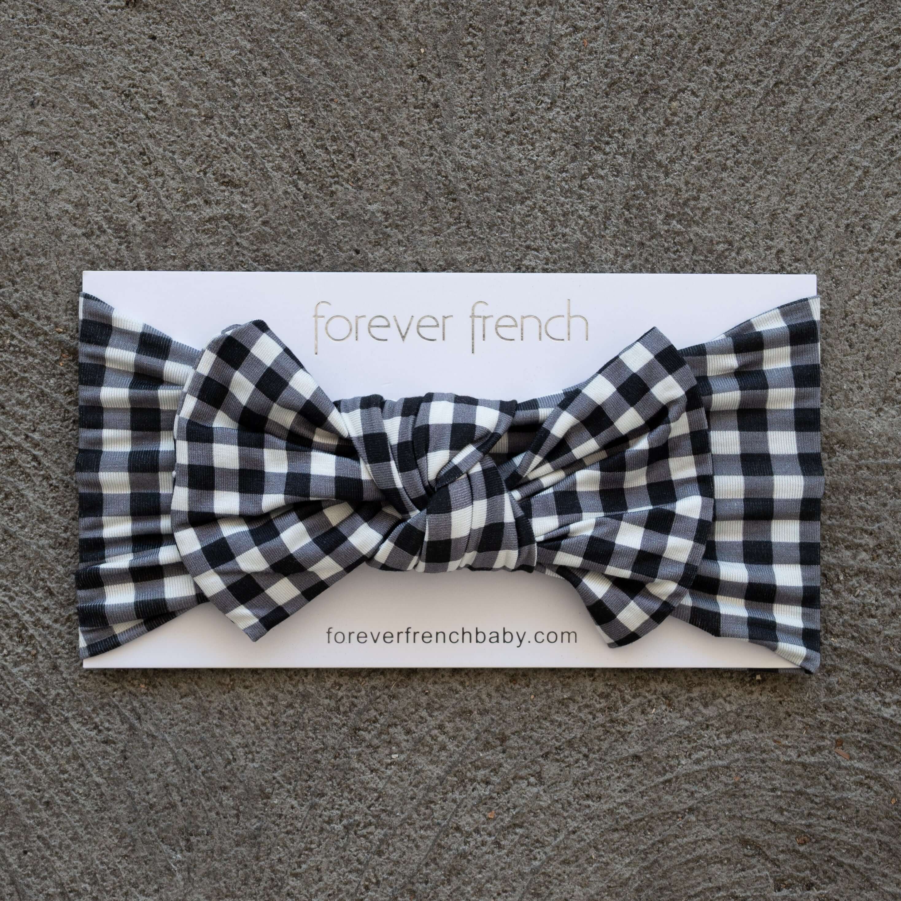 Black Gingham | Bamboo Head Wrap | Made from silky-soft bamboo material, this adjustable head wrap features a sweet bow for added style. Perfect for babies and toddlers!One size fits most Print: Black Gingham Material: 95% bamboo viscose / 5% spandex Care