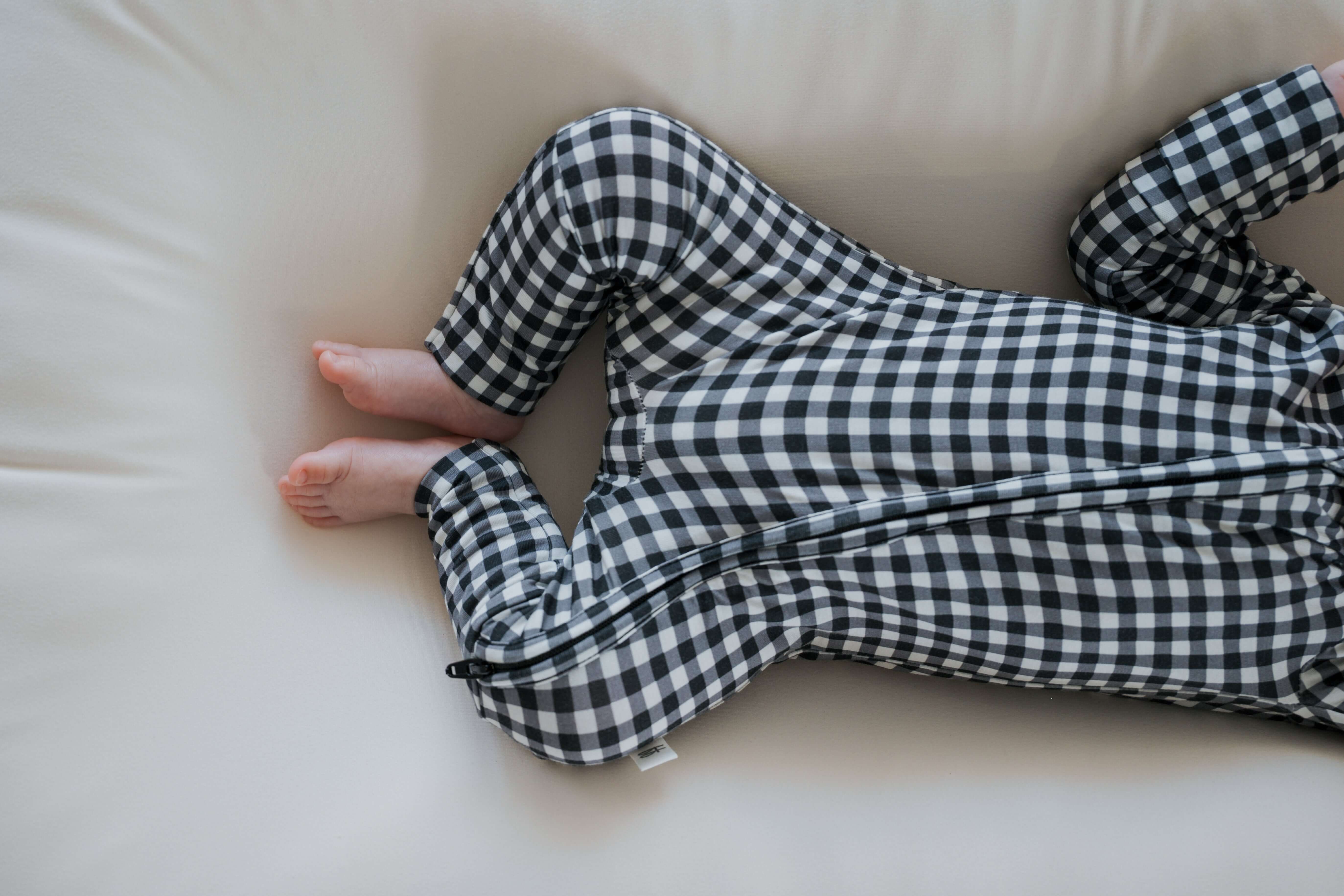 Black Gingham | Bamboo Zip Pajamas | Made of the softest premium bamboo. Durable and well designed your little ones can sleep and play in these cozy pajamas. Our smallest sizes have rollover cuffs on the hands and all of the one piece sizes have cuffs on