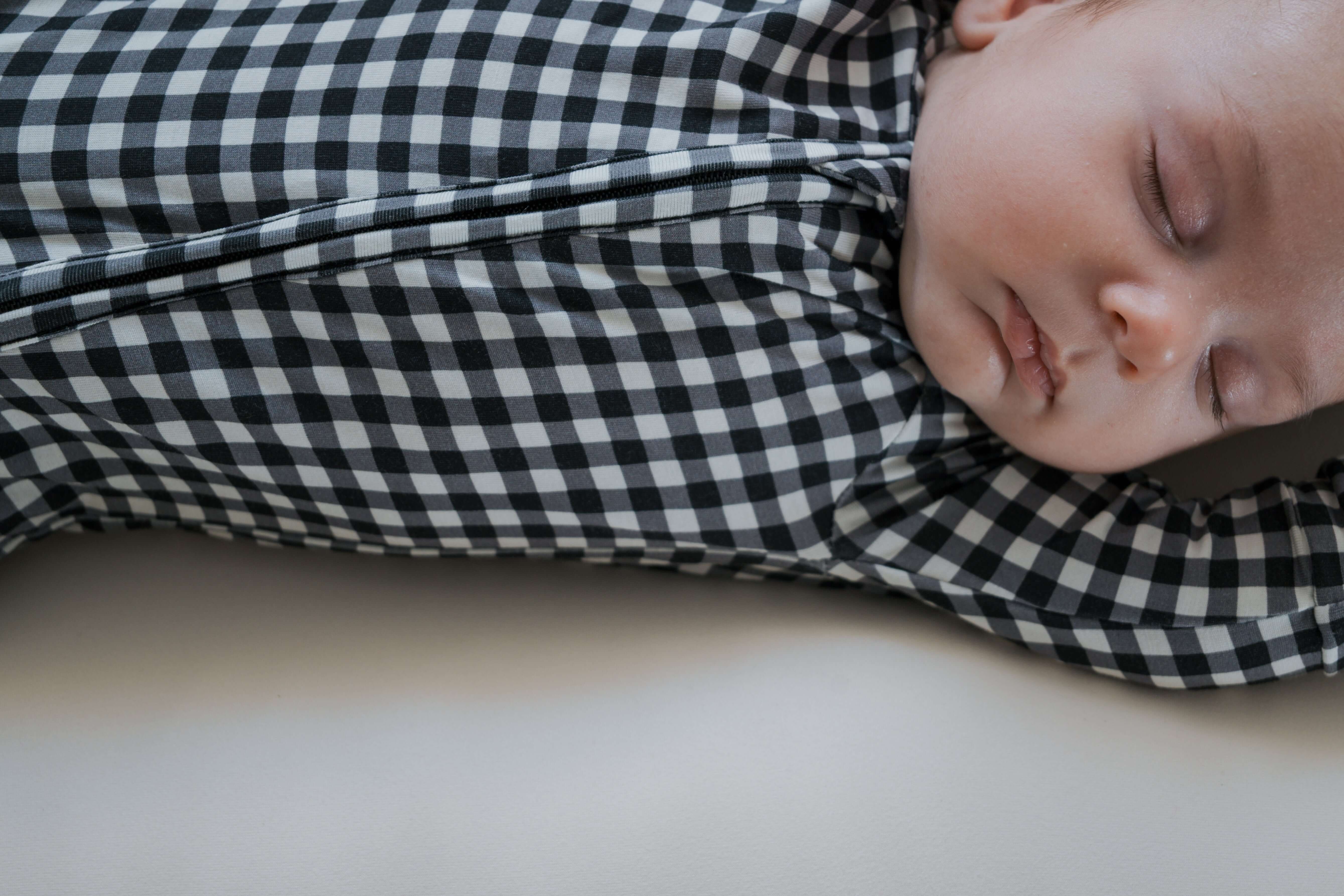 Black Gingham | Bamboo Zip Pajamas | Made of the softest premium bamboo. Durable and well designed your little ones can sleep and play in these cozy pajamas. Our smallest sizes have rollover cuffs on the hands and all of the one piece sizes have cuffs on