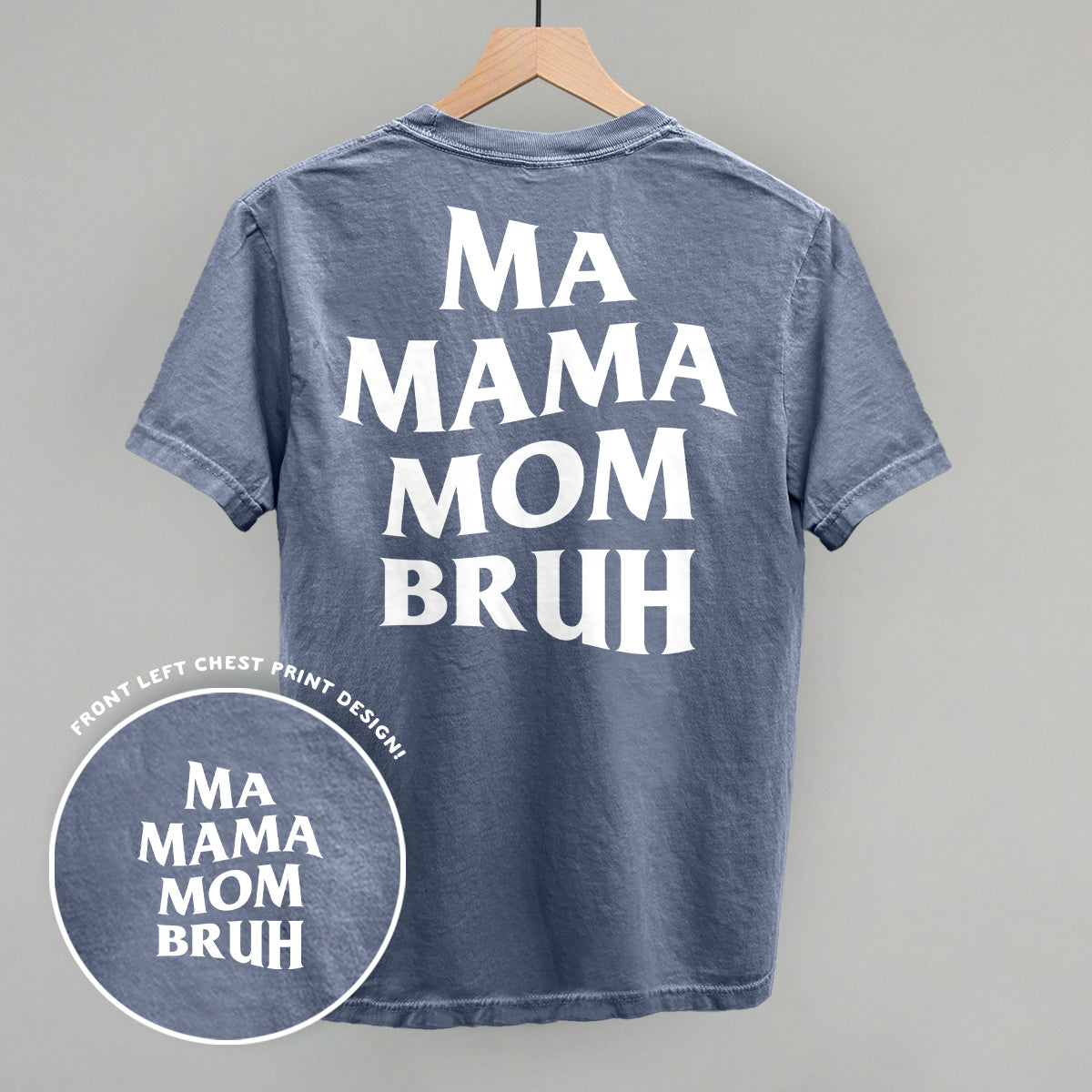 Ma Mama Mom Bruh shirt with back print design, styled hanging on a wooden hanger.