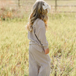 Child in striped loungewear set playing in a field, enjoying comfort and style | Striped Loungewear Set | Babies & Kids.