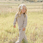 Little girl in striped loungewear set playing outdoors | Striped Loungewear Set | Babies & Kids