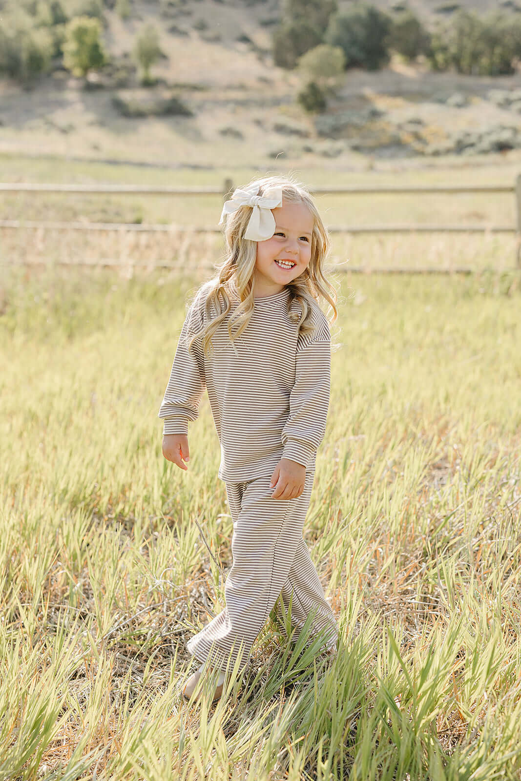Little girl in striped loungewear set playing outdoors | Striped Loungewear Set | Babies & Kids