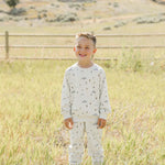 Happy boy wearing the Skier French Terry Set outdoors, perfect for cozy playtime or outings.