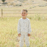 Happy boy wearing the Skier French Terry Set outdoors, perfect for cozy playtime or outings.