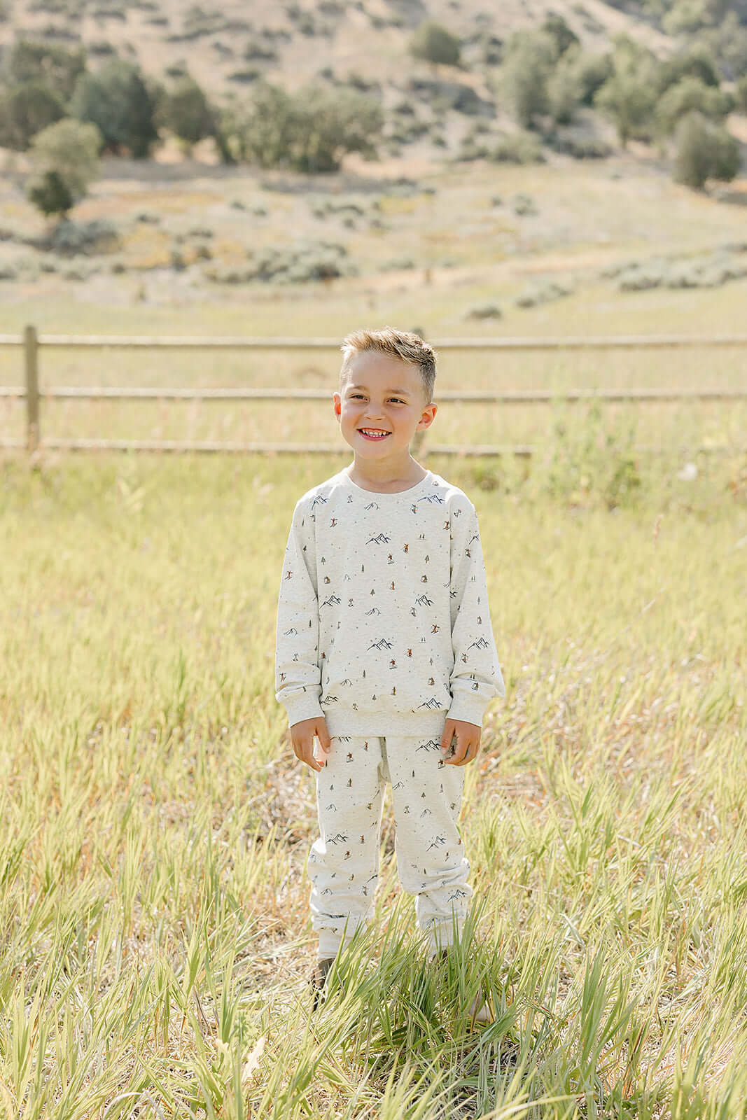 Happy boy wearing the Skier French Terry Set outdoors, perfect for cozy playtime or outings.