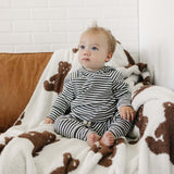 Baby wearing Charcoal Stripe Ribbed Hooded Set sitting on a cozy blanket, looking adorable and comfy.