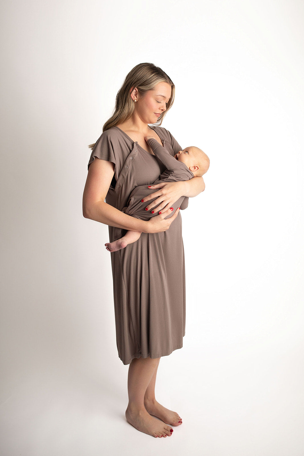 Woman in a cocoa brown Labor & Delivery Gown cradling a baby, showcasing comfort and style for new mothers.