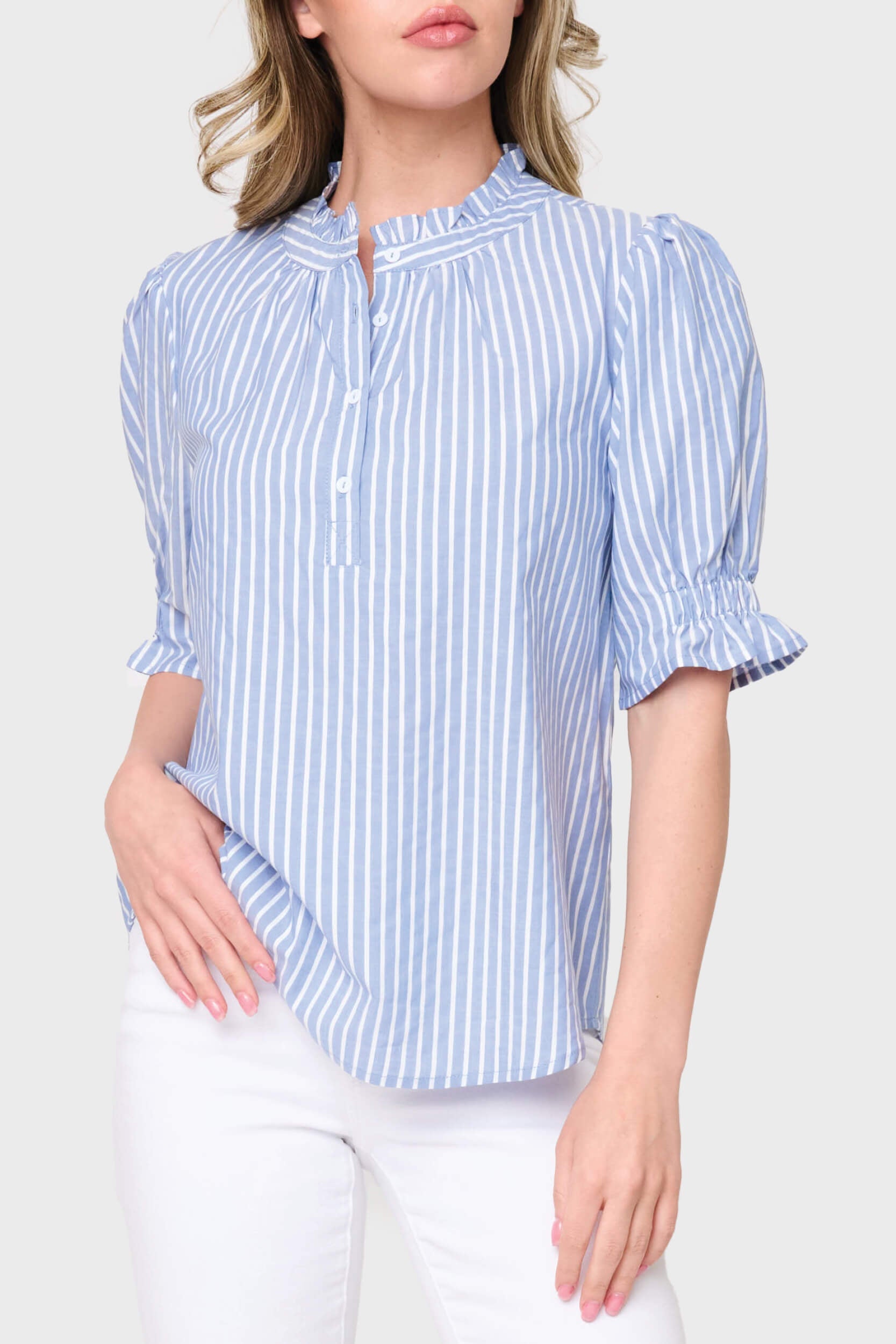 Woman wearing a blue and white striped shirt on a white background