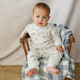 Baby in Skier French Terry Set sitting comfortably on a chair, perfect for playtime or cozy days.
