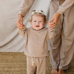 Baby in a Striped Loungewear Set | Babies & Kids, smiling while held by a parent in matching outfit.