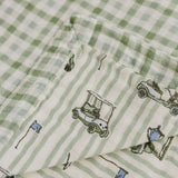 Tee Time + Green Gingham Muslin Quilt | Indulge your little one in the cozy comfort of our Muslin Quilt. Crafted from the same fabric as our beloved muslin swaddles, this four-layer quilt offers warmth and softness for a restful sleep. Our neutral colors
