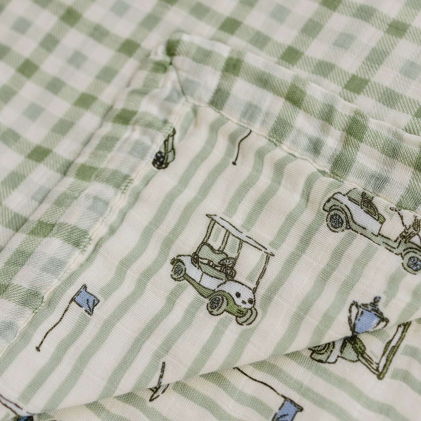 Tee Time + Green Gingham Muslin Quilt | Indulge your little one in the cozy comfort of our Muslin Quilt. Crafted from the same fabric as our beloved muslin swaddles, this four-layer quilt offers warmth and softness for a restful sleep. Our neutral colors