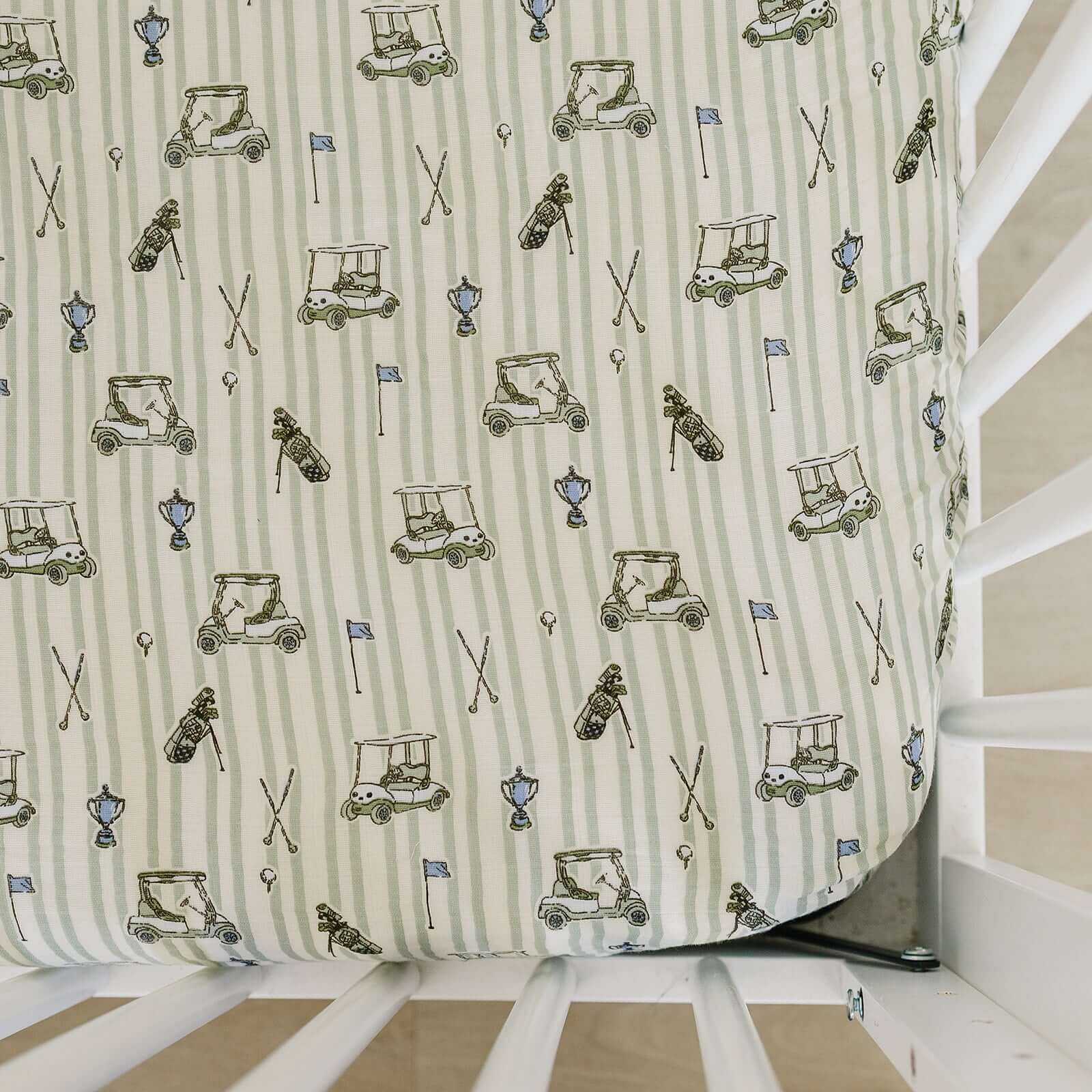 Tee Time Muslin Crib Sheet | Transform your baby's crib into a cozy haven with our Tee Time Muslin Crib Sheet. Crafted from our exclusive soft and breathable muslin fabric, this sheet showcases a neutral design that adds a touch of warmth and style to the