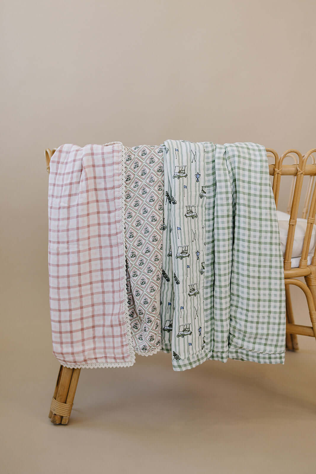 Tee Time + Green Gingham Muslin Quilt | Indulge your little one in the cozy comfort of our Muslin Quilt. Crafted from the same fabric as our beloved muslin swaddles, this four-layer quilt offers warmth and softness for a restful sleep. Our neutral colors