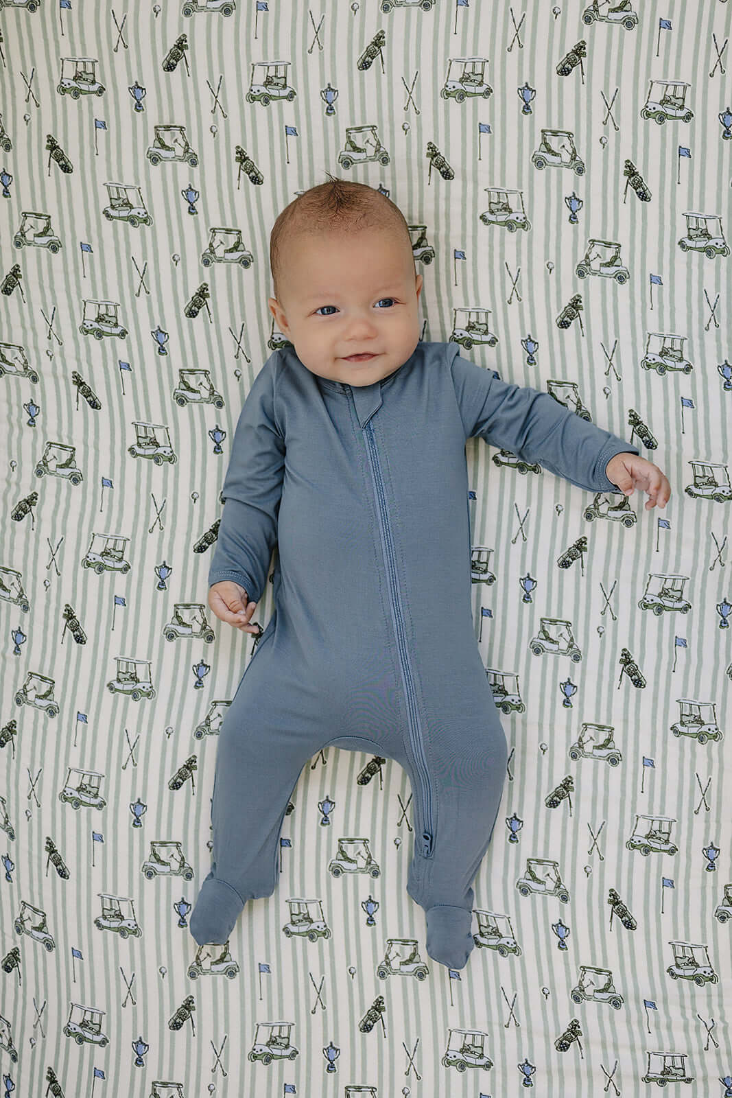 Tee Time Muslin Crib Sheet | Transform your baby's crib into a cozy haven with our Tee Time Muslin Crib Sheet. Crafted from our exclusive soft and breathable muslin fabric, this sheet showcases a neutral design that adds a touch of warmth and style to the